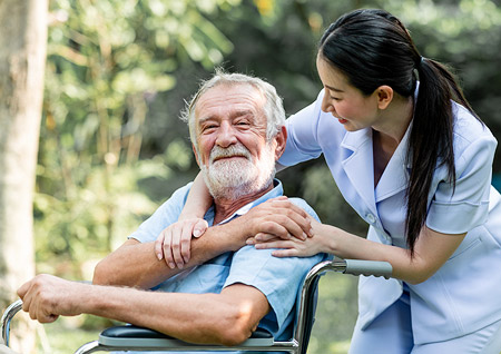 Volunteer with patient in wheelchair