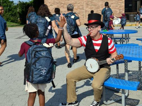 camp compass camper with musician